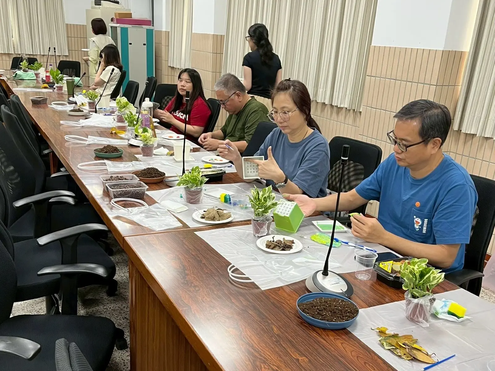 輔仁大學老師們參加園藝治療工作坊，桌上擺著植物與彩繪材料